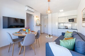 A modern kitchen with white cabinets, a microwave, and a coffee maker. - Cozy apartment in Naciones with beautiful view (Benalmádena)