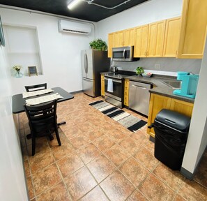 A compact kitchen with a refrigerator, microwave, stove, and sink. - Steps to downtown Penn Yan, pet & family friendly 2BR! Board games galore!  (Penn Yan)