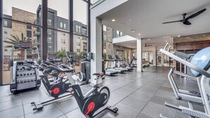 A gym with stationary bikes, treadmills, and weight machines.