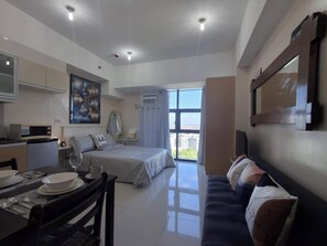 Comfort Studio, 1 Queen Bed with Sofa bed, Pool Access, City View | Living area - Your Cozy Escape at The Viceroy (Taguig)