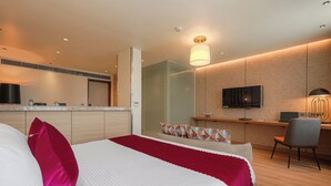 A modern hotel room with a bed, a desk, a TV, and a bathroom. - Ramee Collection Airport Road Mohali (Mohali)