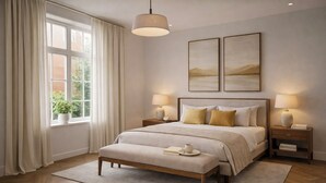 A bedroom with a large bed, two bedside tables, a hanging light, a window with curtains, and two framed pictures on the wall. - Cozy 2-Bed in Central London (London)