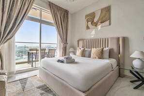 A hotel room with a large bed, a city view, a dining area, and a modern art piece on the wall. - Free Housekeeping Visits During Your Stay - Stayshort - Cozy Studio in Arjan That Sleeps 2 (Dubai)