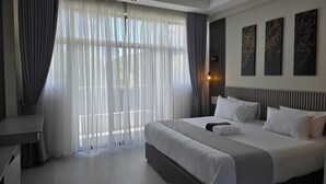 A modern hotel room with a large bed, a desk, and a view through sheer curtains. - OLOISIRI NAMANGA HOTEL (Namanga)