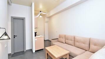 Family Apartment, Courtyard View | Living area | 75-cm flat-screen TV with digital channels