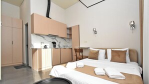 A modern hotel room with a bed, a small kitchenette, and a bathroom. - Seva Apart-Hotel (Yerevan)