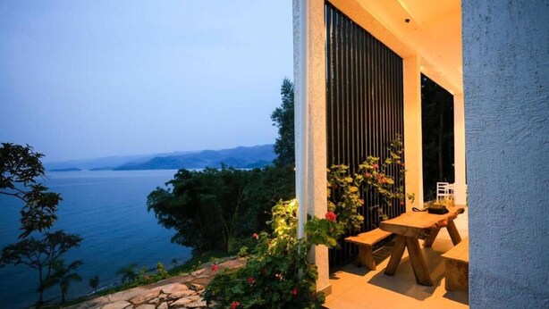 A modern outdoor seating area with a view of the sea.