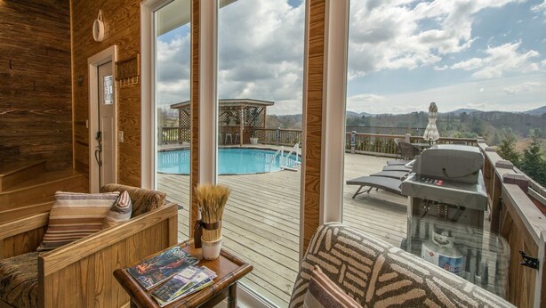 A wooden deck with a pool, lounge chairs, and a barbecue grill. - Poolside ADU w Sauna Free Tix Tiki Bar Retreat (Candler)