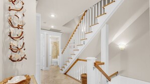 A staircase with white railings and wooden handrails, leading to an upper floor. - Your Front-Row Seat to Paradise, Pool, Balconies – Sleeps 14 (Miramar Beach)