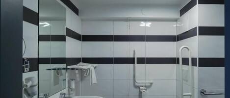 Un baño con lavamanos, inodoro y espejo.