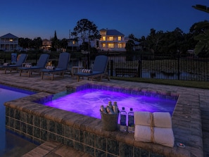 Un espace piscine avec des chaises longues et un jacuzzi.
