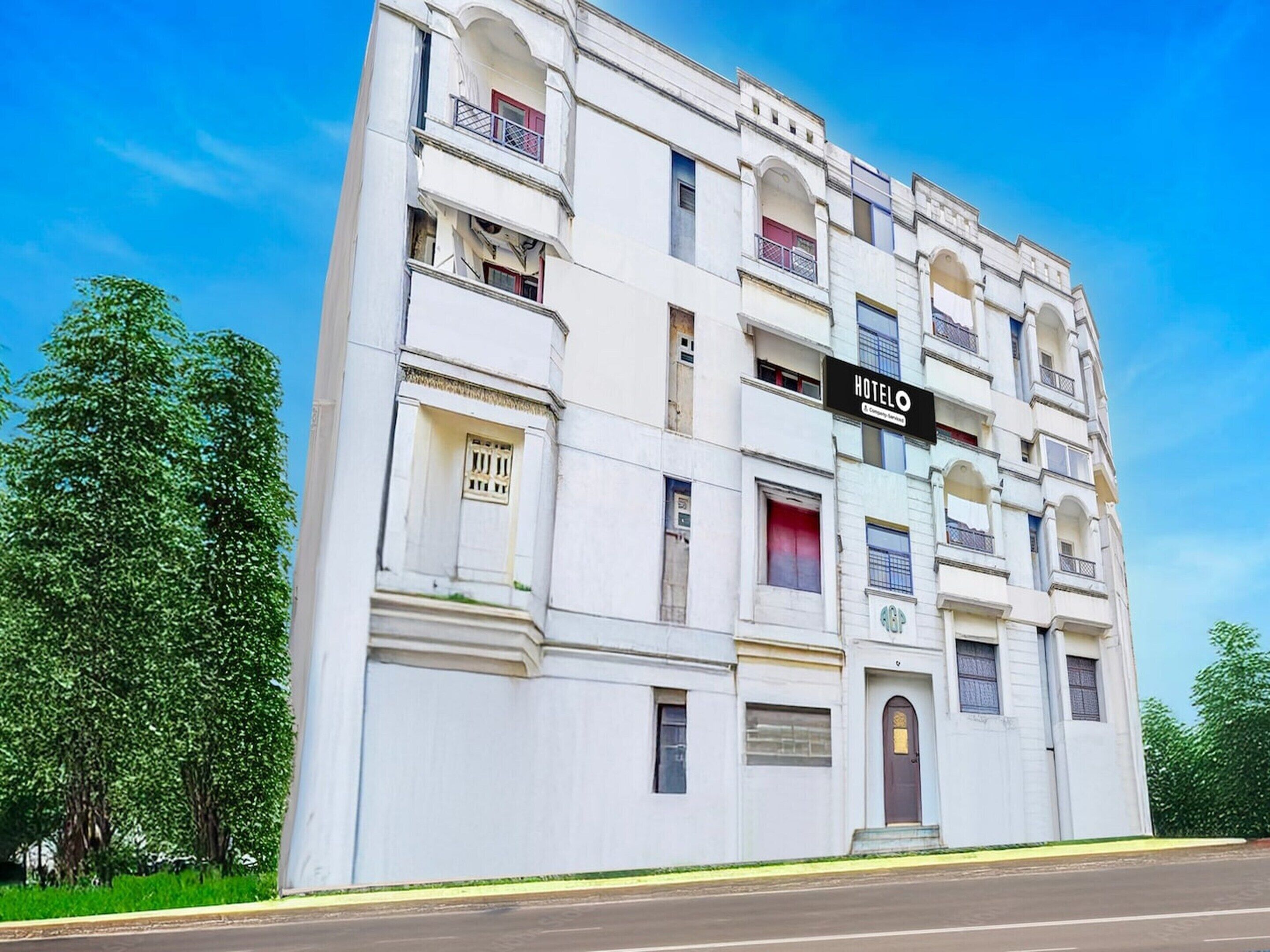 A multi-story hotel with a prominent 'HOTEL' sign, balconies, and a classic architectural style.