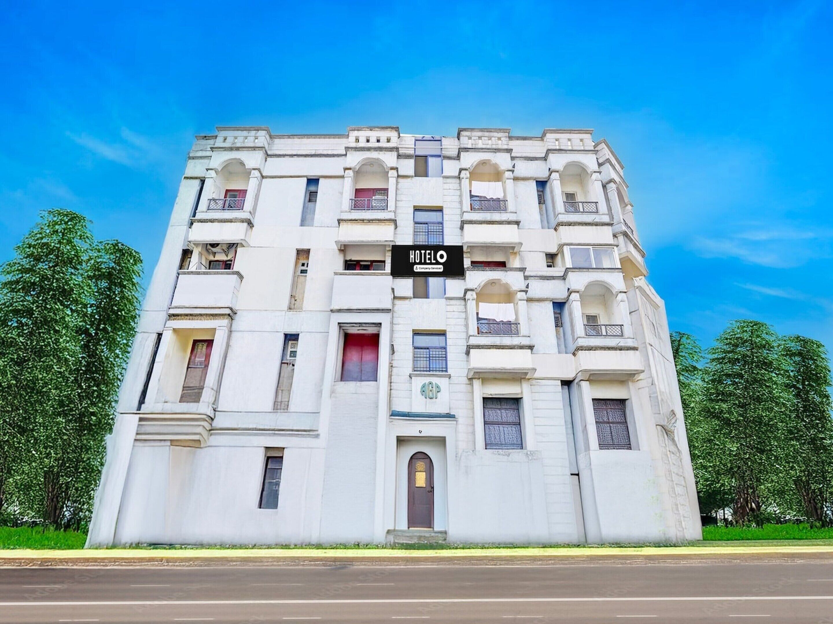 A multi-story hotel with a prominent 'HOTEL' sign, arched windows, and a central entrance.