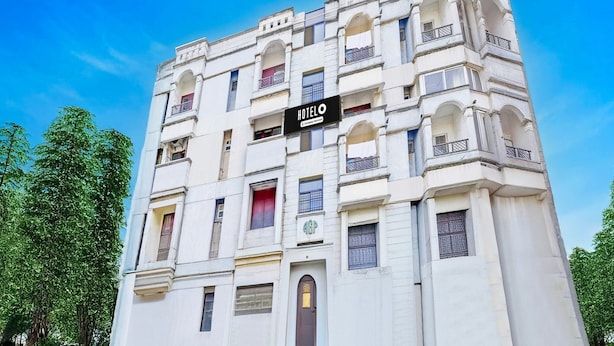 A multi-story hotel with a classic architectural style, featuring balconies and arched windows.