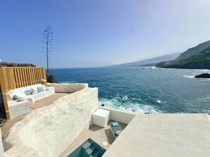 A seaside terrace with a pool, seating area, and a view of the ocean. - Casa Riva, Private Villa with Pool Facing the Sea (Las Aguas)