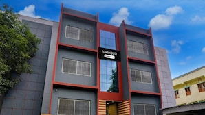 A multi-story building with a sign reading 'TOWNHOUSE' and a company-serviced logo. - Deluxe Seven Hills Aurangabad (Chhatrapati Sambhajinagar)