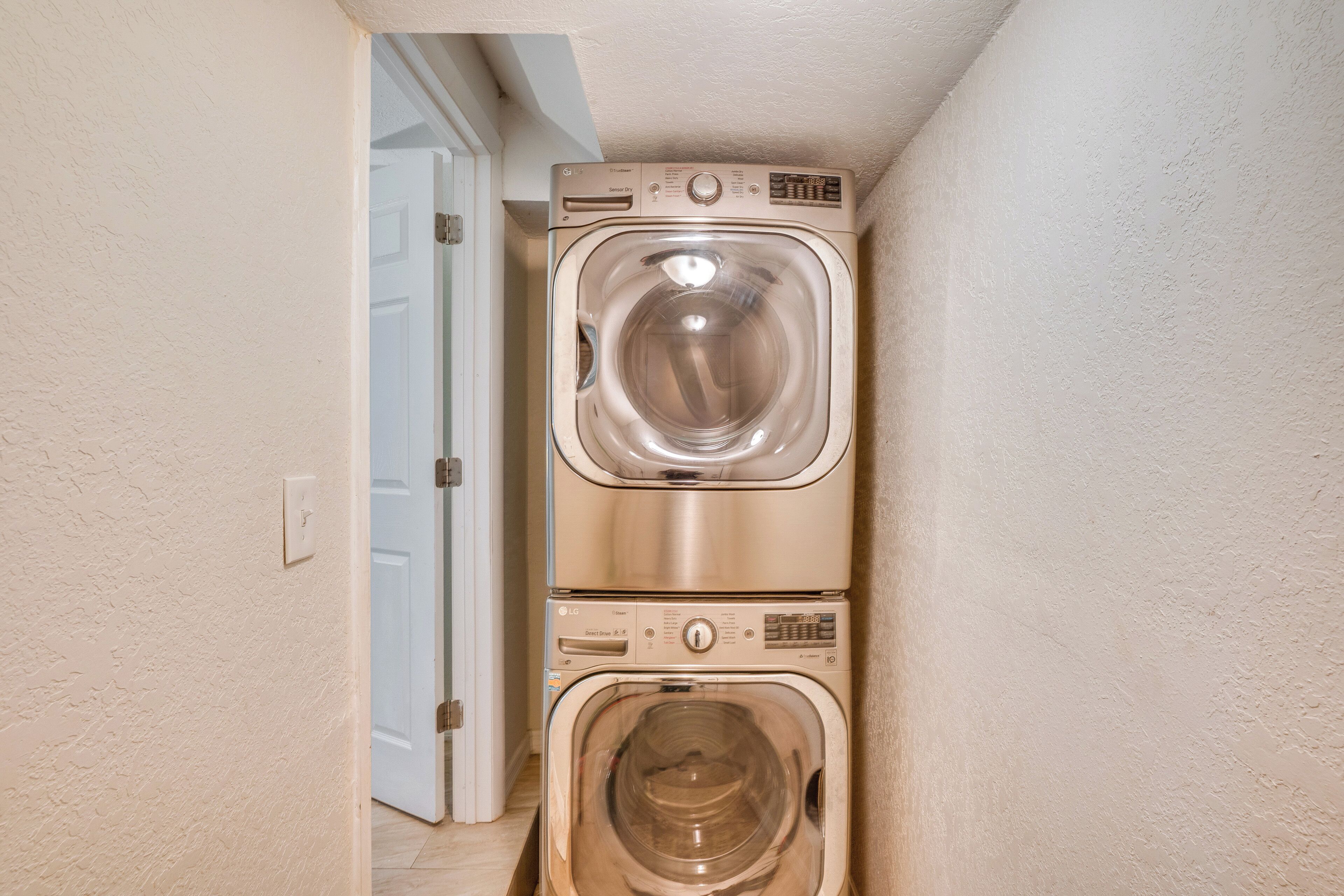 A laundry room with two stacked front-loading washing machines.