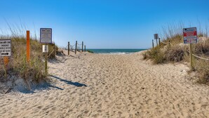 A sandy beach path with signs indicating beach access and emergency vehicle access. - New Oak Island Home w/ Ocean Views! (Oak Island)