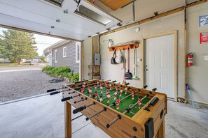 A garage with a foosball table, a fire extinguisher, and a door with a mailbox. - Near Pine Knob, Lakes & Trails! Ortonville Getaway (Ortonville)