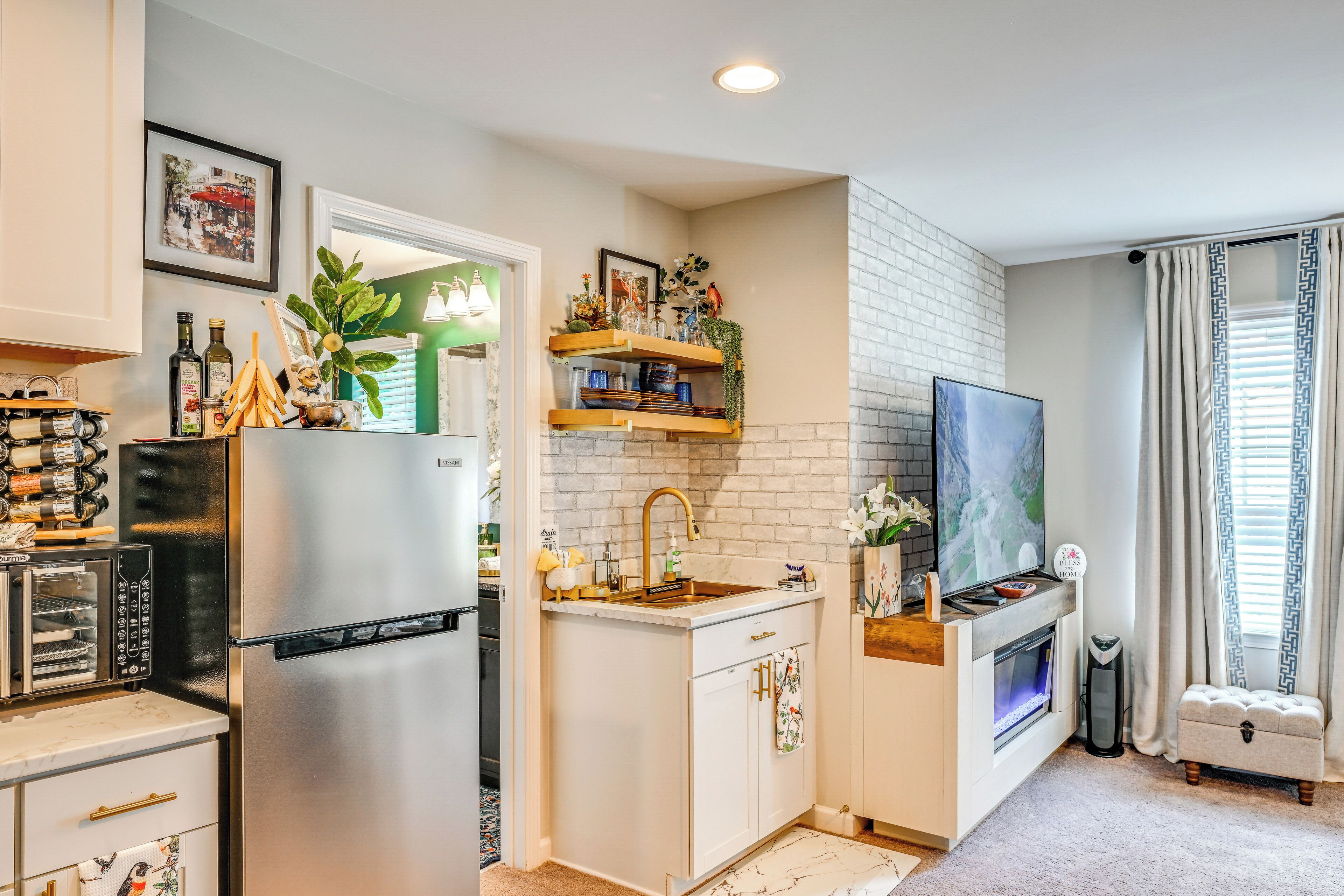 A compact kitchen with a built-in refrigerator, a sink, and a small countertop area.