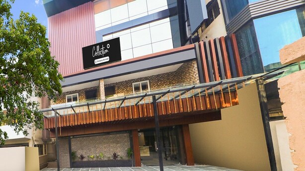 A modern building with a prominent 'Collection' sign, a covered walkway, and a mix of brick and glass facade. - Super Collection O Ranchi Station Road (Ranchi)