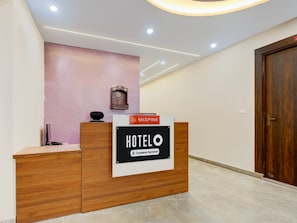 A reception desk with a sign indicating it's a company-serviced hotel.