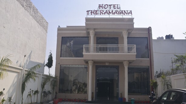 A hotel with a large entrance, a balcony, and a sign above the entrance. - The Ramayan (Orchha)