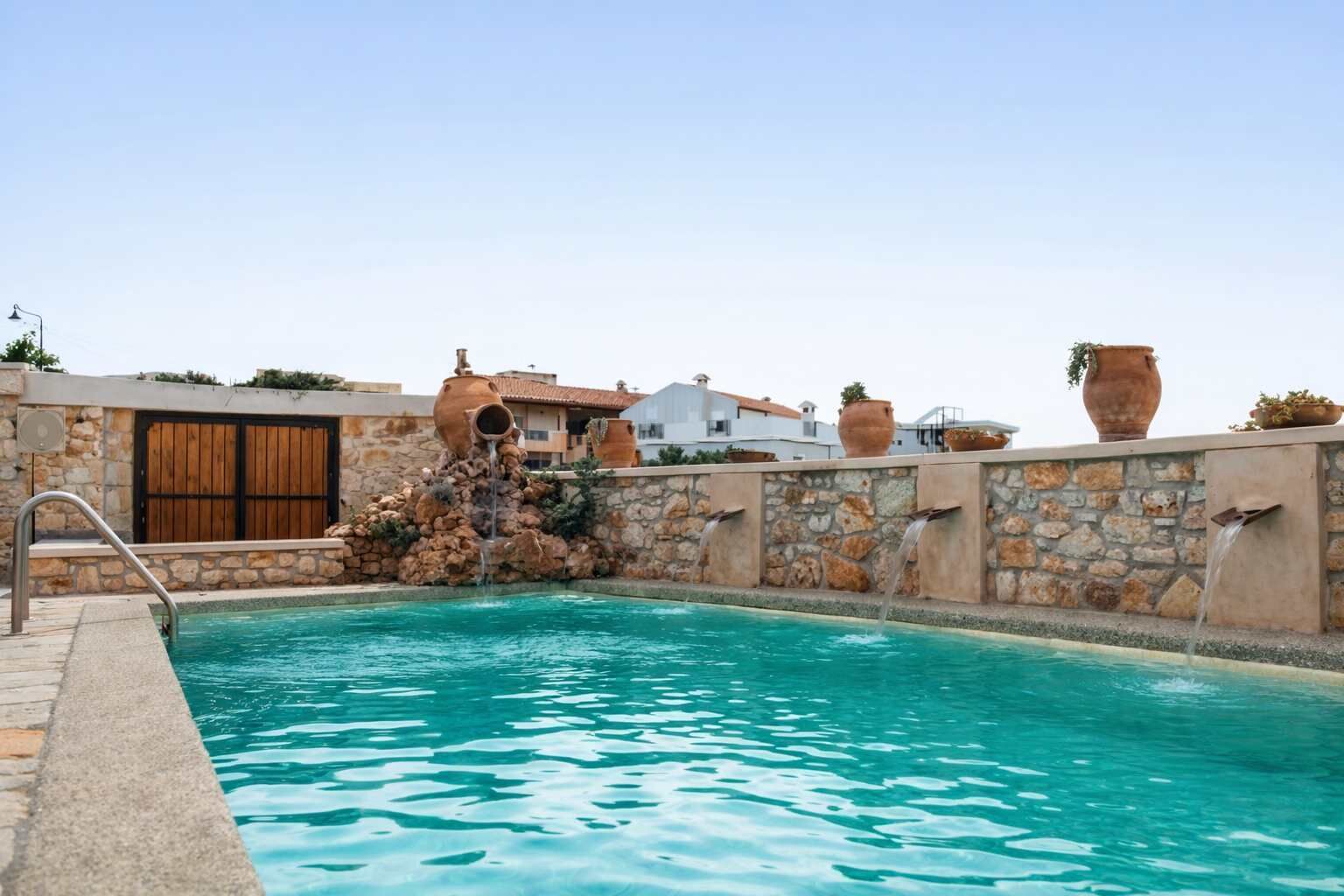 Private pool with surrounding stone walls and open sky, offering a calm space for swimming and relaxing.