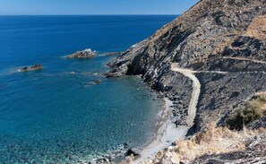 A coastal landscape with clear blue waters, rocky terrain, and a narrow path along the cliff. - Vertigo Stone Villa - Roumeli Private Pool Escape (Roumeli)