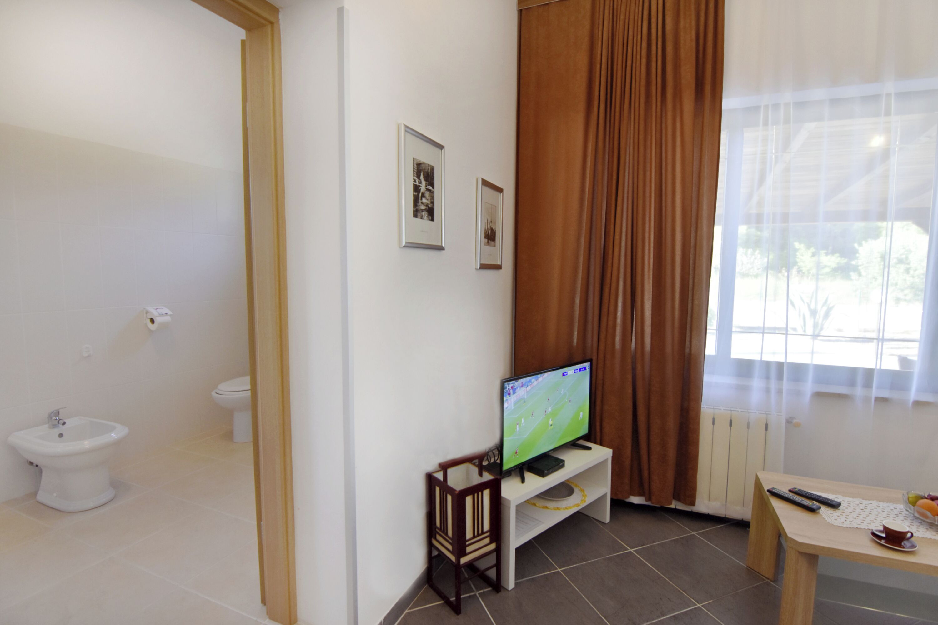 A bathroom with a toilet, bidet, and sink.