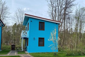 A two-story blue house with a small porch and a chimney. - Comfortable holiday home (No. 4), summer pool (Rewal)