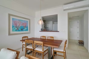 A dining area with a wooden table and chairs, a pendant light, and a framed painting on the wall. - ®{3BR~Hemingway~Retreat}@JuanDolio+Pool (Juan Dolio)