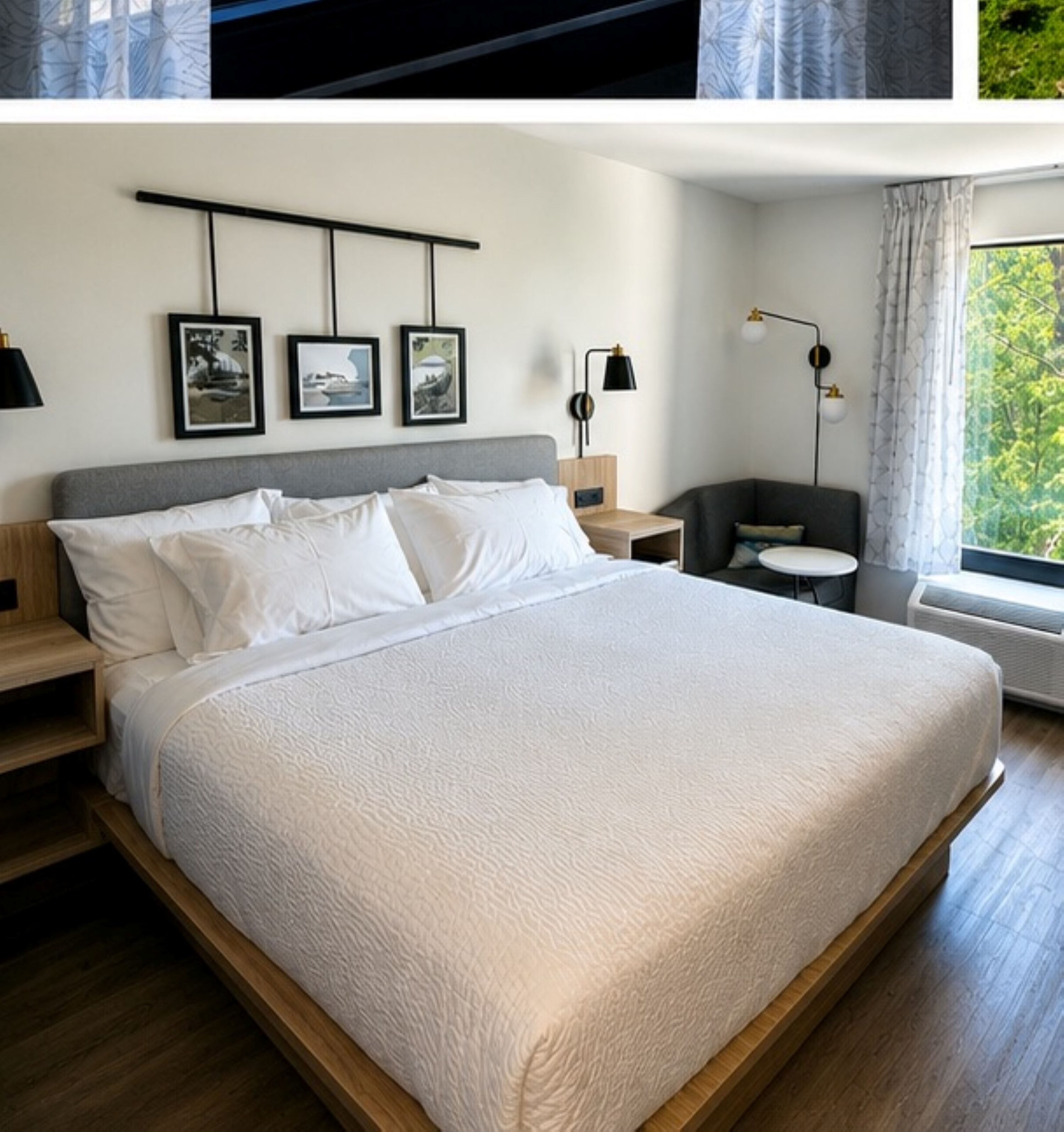 A modern bedroom with a large bed, bedside tables, a desk, and a view of greenery.