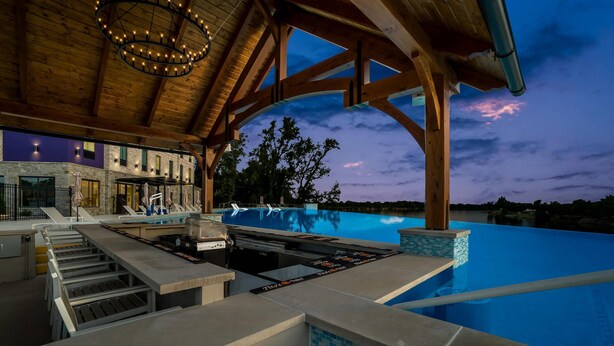 A poolside area with a built-in grill, a covered seating area, and a view of the pool. - Sleep Inn & Suites Savannah Tennessee Riverfront (Savannah)