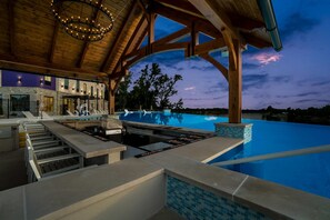 A poolside area with a built-in grill, a covered seating area, and a view of the pool. - Sleep Inn & Suites Savannah Tennessee Riverfront (Savannah)