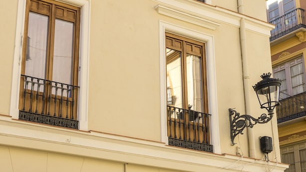 A multi-story building with balconies, large windows, and a street lamp. - Housing Fana by Sharing Co 3PAX (Málaga)