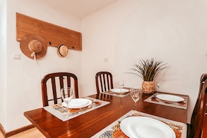 A dining table set with plates, glasses, and a woven plant pot. - Alentejo Poolside By Gt House (Estremoz)