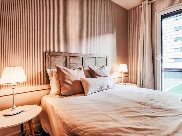 A hotel room with a large bed, two bedside tables, and a window with curtains. - Bridge View With Balcony By Gt House (Lisbon)