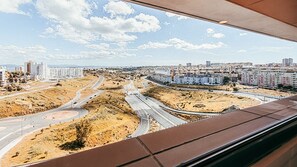 A cityscape with multiple highways, residential buildings, and a clear sky. - Trendy Apartment River View By Gthouse (Lisbon)