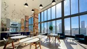 A modern interior with large windows, multiple seating areas, and a city view. - Brickell Area| Free Parking| Balcony| Rooftop Pool (Miami)