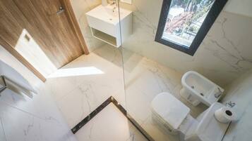 Un baño moderno con inodoro, bidé y lavamanos.