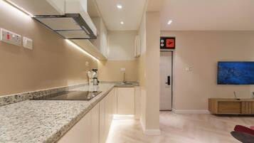 A modern kitchen with granite countertops, a built-in stove, and a microwave.