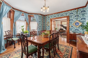A dining room with a wooden table, chairs, and a chandelier. - The Painted Petal: A Historic 5 Bedroom Mini Estate Perfect for Groups (Breinigsville)