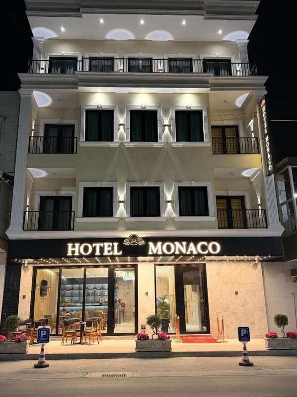 A multi-story hotel with a prominent sign reading 'HOTEL MONACO.' - Hotel Monaco (Kamez)
