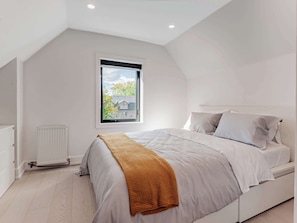Calm, comfortable sleeping space with fresh linens and storage.