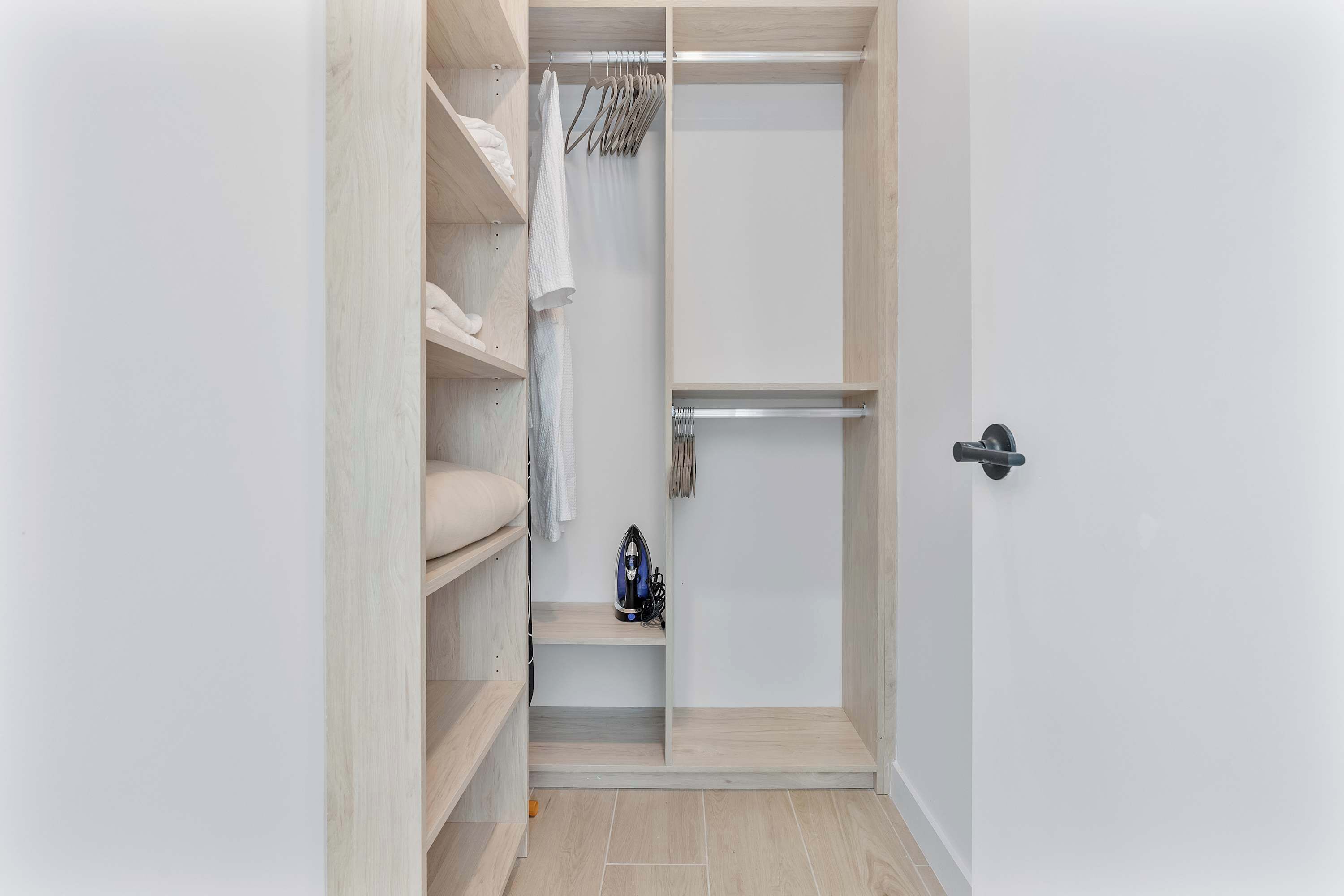 A walk-in closet with shelves, hanging space, and a shoe rack.