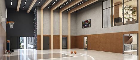 Una amplia cancha de baloncesto cubierta con marcador, vigas de madera y grandes ventanales.