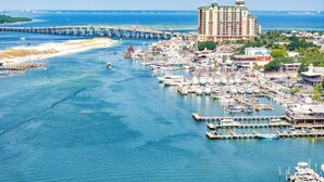 A marina with numerous boats, a large hotel, and a pier extending into the water. - Waterfront townhome with private & Public beach access + paddle to Destin Harbor (Destin)