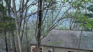 A house with a stone pathway leading to a wooden gate marked '104'. - Bent Tree Family 2BR - Hot Tub, Mountain View Deck, Pool, Golf, Lake & Fish (Jasper)