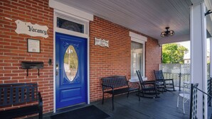 A brick building with a blue door, a sign indicating vacancy, and a sign for Old Clark Inn established in 1924. - Old Clark Inn (Marlinton)